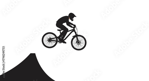 Silhouette of a Cyclist Performing a Jump on a Bike, on a Ramp