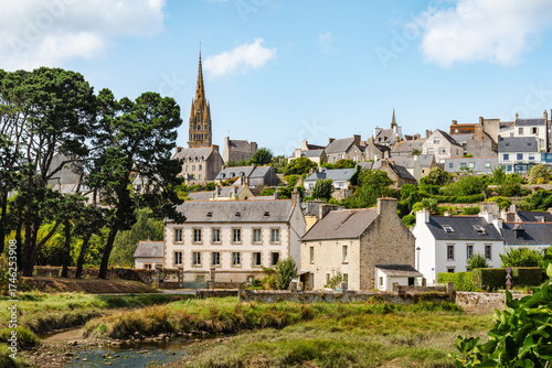 Scenic French Village of Pont-Croix, in Brittany, With River, Stone Homes, Green Hills, and a Dominant Tall Church Spire