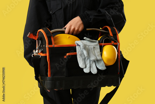 Worker with tool bag and ha...