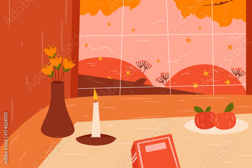 Still life of vase flowers, candle, apples, and book near a wide fall landscape window.
