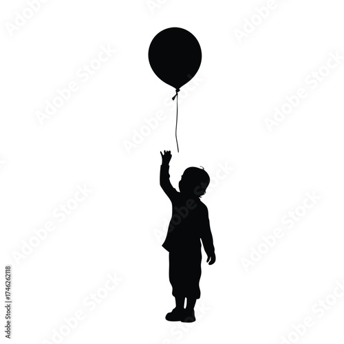 A child reaching for a floating black balloon in silhouette