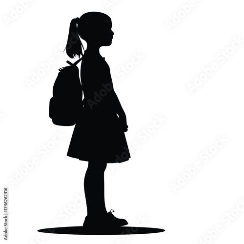 Silhouette of a young girl with backpack walking to school