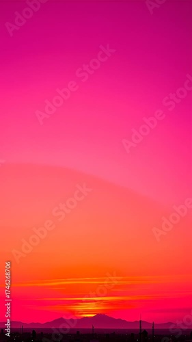 Vibrant Sunset Sky Transitioning from Orange to Pink with Silhouetted Horizon in Evening Panorama View