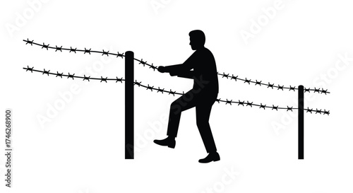 Silhouette of a man carefully climbing over a barbed wire fence symbolizing challenges overcoming or boundary crossing for freedom pursuit