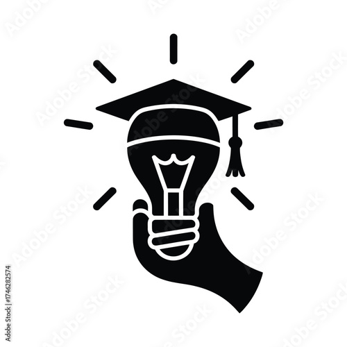 Hand holding a lightbulb with graduation cap symbolizing education and knowledge