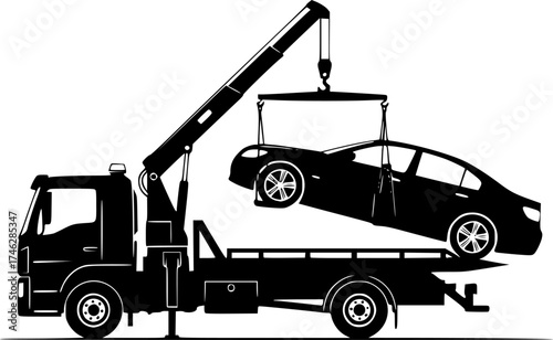 A black tow truck lifting a black car