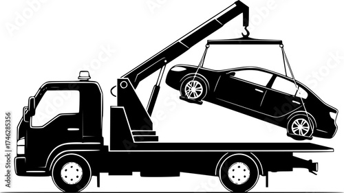 A black tow truck lifting a black car