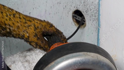 A plumber snaking the bathtub drain 