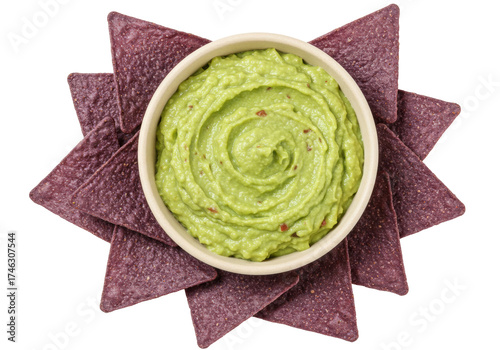 Delicious guacamole in bowl with blue corn tortilla chips isolated, healthy avocado dip for Cinco de Mayo party appetizer