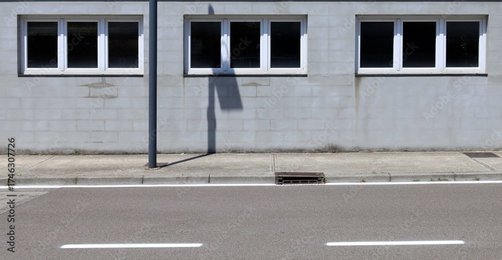 custom made wallpaper toronto digitalCinder block facade with three PVC windows. Concrete sidewalk and street in front. Background for copy space.