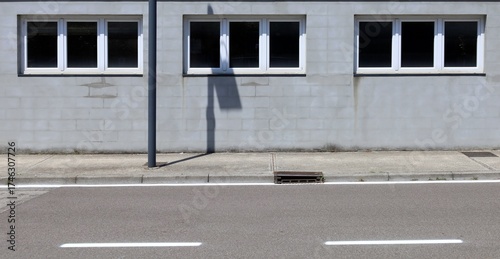 Wallpaper Mural Cinder block facade with three PVC windows. Concrete sidewalk and street in front. Background for copy space. Torontodigital.ca