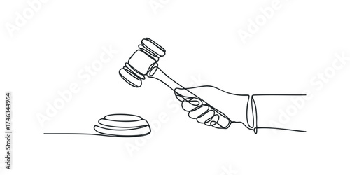 Hand holding judge's gavel striking sound block