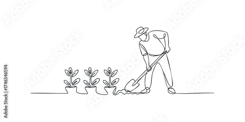 Gardener wearing hat digging soil with shovel next to potted plants