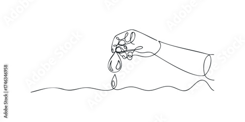 Hand pouring liquid droplet into water