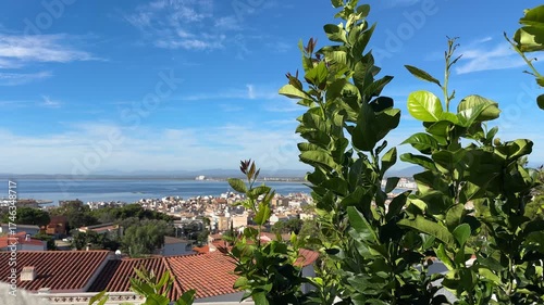 Aerial View from above of tiled rooftops of Mediterranean Coastal touristic city houses. Beautiful sea bay at sunny summer day, vacations in Spain, white house for vacation, swimming pool.