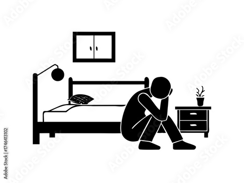 Depressed man sitting on bedroom floor

