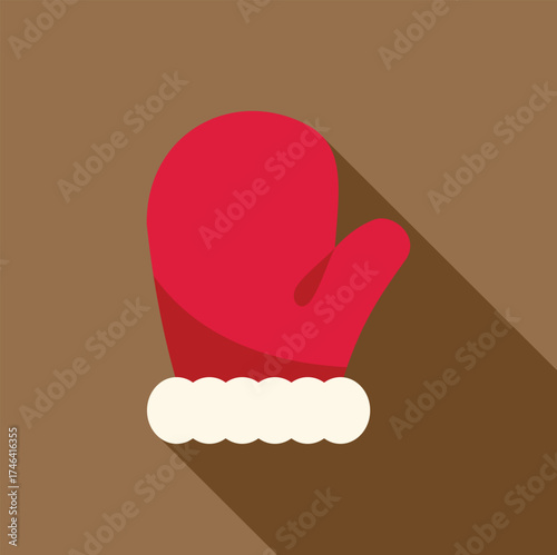 Red christmas oven mitt with white trim casting a long shadow over brown background, perfect for holiday baking projects