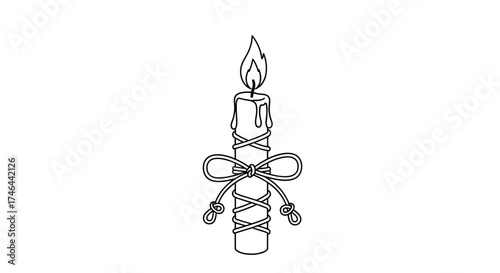 A lit candle wrapped in string and adorned with a bow.