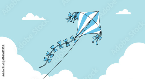 A blue and white kite with a long tail flies high in the sky.