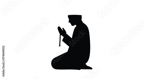 Silhouette of a muslim man in prayer with prayer beads