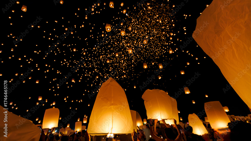 Αυτοκόλλητο A breathtaking low-angle shot of the Yee Peng festival in Chiang Mai, showing hundreds of illuminated sky lanterns (Khom Loi) ascending into the dark night sky