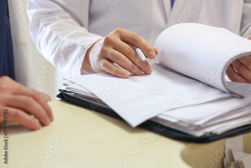 Close-up of a medical record and a doctor's hand with a pen. Treatment plan. Medicine concept.