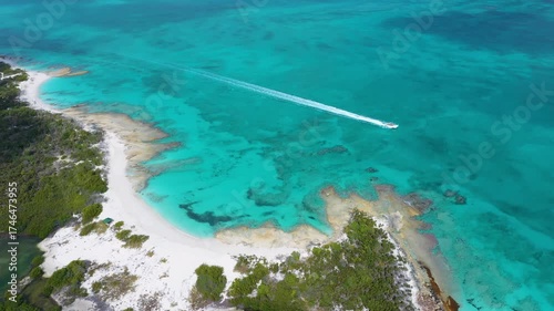 Aerial view of a speedboat on a stunning tropical costline.