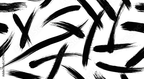 Dynamic seamless pattern of hand-painted black ink strokes on a white surface, creating an energetic abstract background