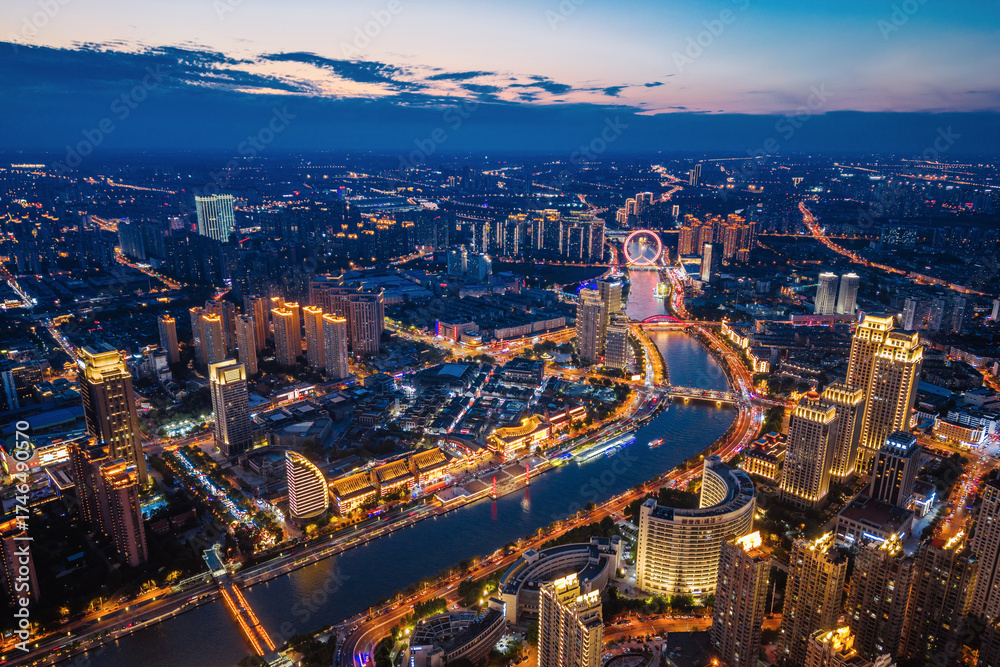 Fototapeta premium Aerial night view of Tianjin Eye Ferris wheel and city skyline in Tianjin, China