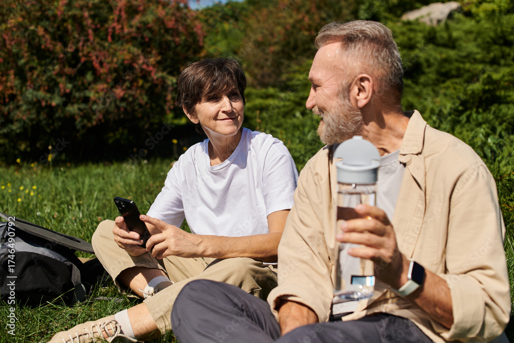 Fototapeta premium Active seniors exploring nature together, enjoying a mountain hike