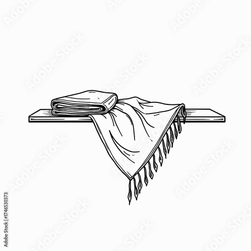 Folded blanket and shawl draped over a wooden shelf in minimal style  