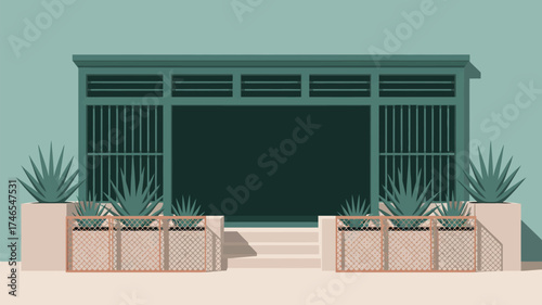 A teal building with a dark green opening and plants in pots with a light pink fence in the foreground