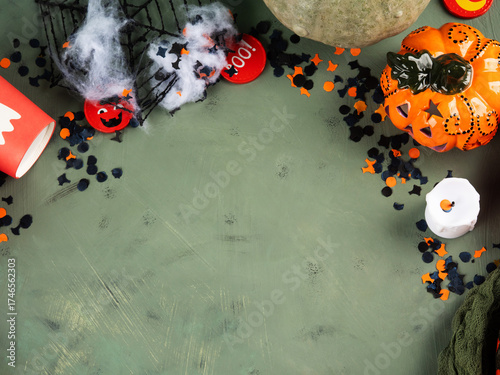 Halloween green frame background flatlay with pumpkins and party decor