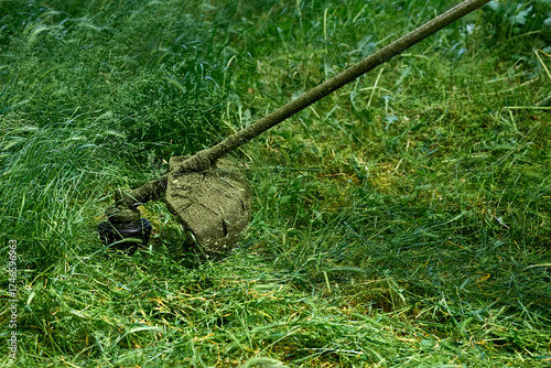 Obraz na płótnie Professional grass cutting on green lawns.Handle lawn mower