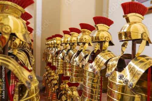 Ancient Roman legionary helmets and armor gleaming in gold, historical strength and tradition.