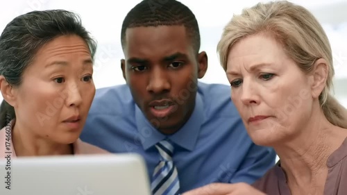 Business people discussing laptop