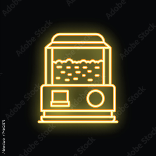 Bright yellow neon icon of a popcorn machine making fresh popcorn glowing on a black background