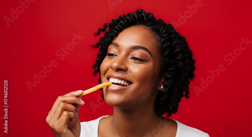 A vibrant close-up portrait captures a cheerful young woman with beautiful curly hair, radiating pure happiness as she enjoys a golden fried potato stick. Her wide, genuine smile and bright eyes conve