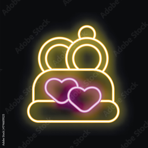Bright yellow neon sign showing a wedding cake with two hearts on top, perfect for themes like marriage, love and celebration