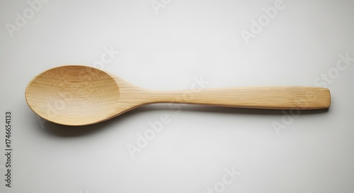 Simple wooden spoon isolated on a plain white background