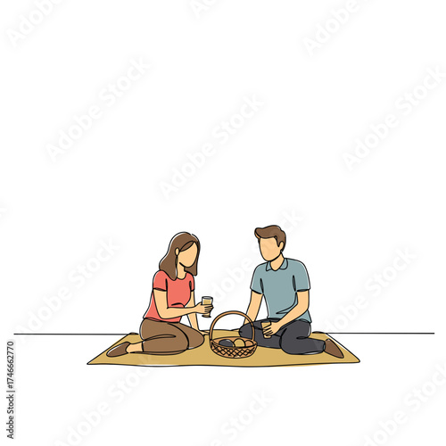 Couple enjoying a picnic on a blanket with food and drinks  