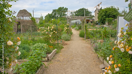 Ecological comunity garden with green vegetables and colorful flowers in Rennes, France 