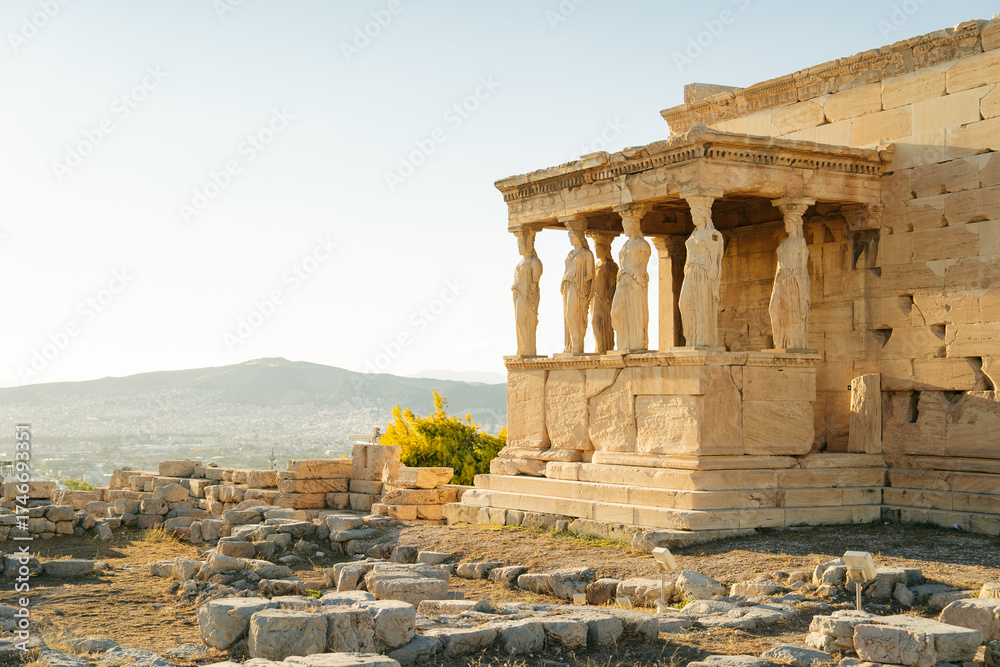 Fototapeta premium Soft morning light illuminating the marble ruins of the Acropolis in Athens, Greece. The ancient columns and stones reflect the warm tones of the sun, creating a peaceful and timeless atmosphere