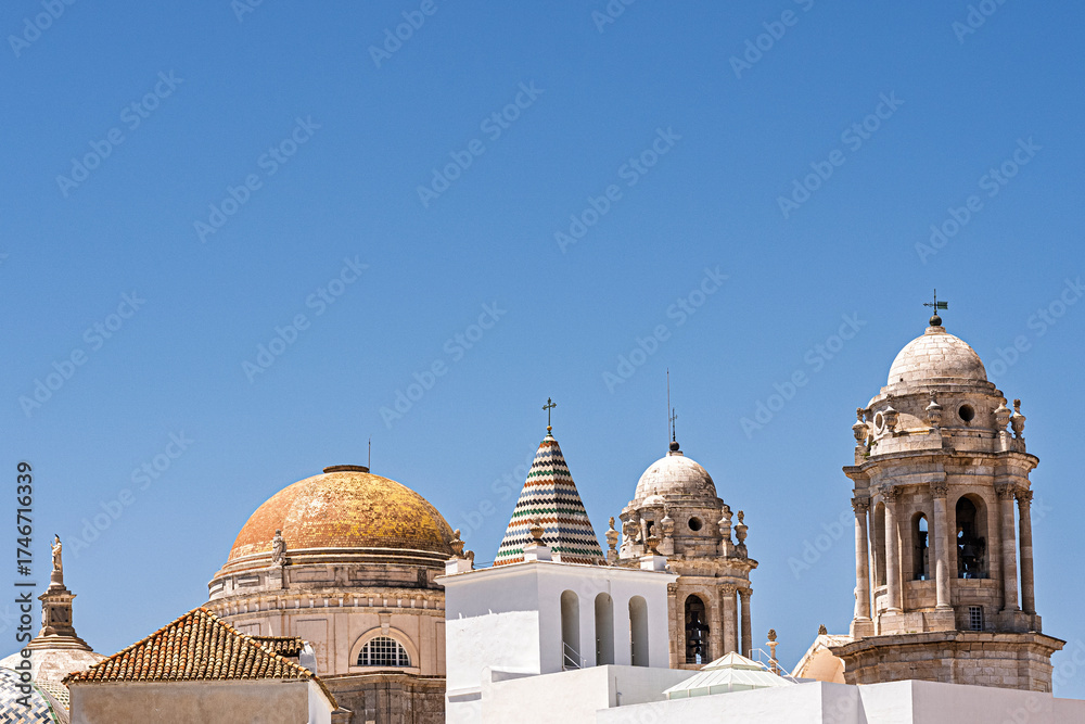 Naklejka premium The roof and towers of the Catedral de Cádiz, the Cathedral in the city of Cadiz, on the coast of Spain.