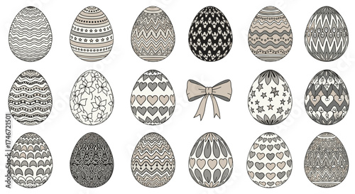 A collection of black and white ornamental Easter eggs and a decorative bow arranged in rows.