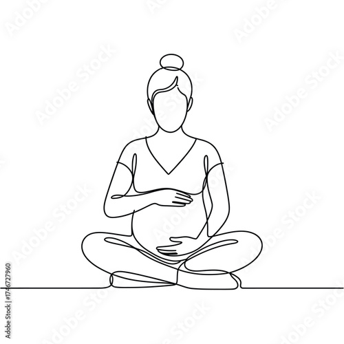 Pregnant woman sitting in meditation pose with hands on belly