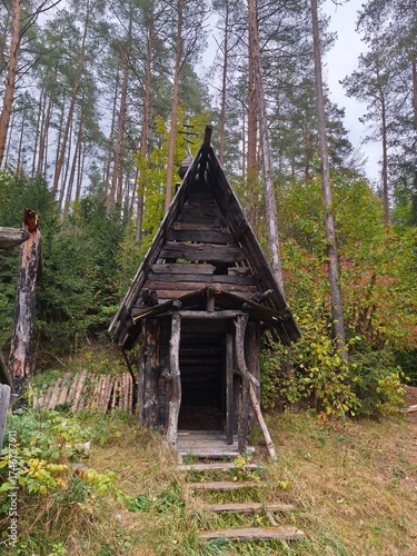 Old wooden house in the forest. Ancient wooden huts
