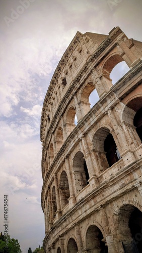 Photography Vertical close-up photo of the famous Colosseum in Rome, Italy, captured in warm sunlight