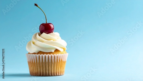 Single cupcake with golden-brown base, white frosting swirl, and red cherry topper on light blue background