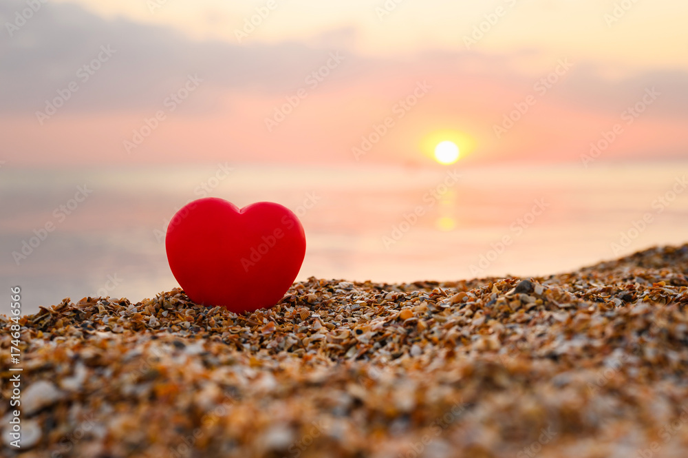 Fototapeta premium Red heart on the seashore. Romantic sunset on the seashore.